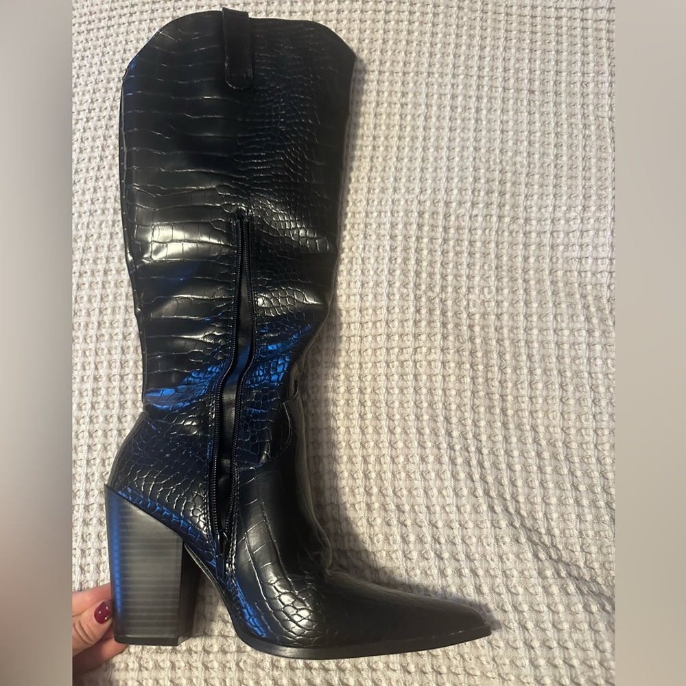 Faux snakeskin knee high boots. Give off cowgirl vibes.